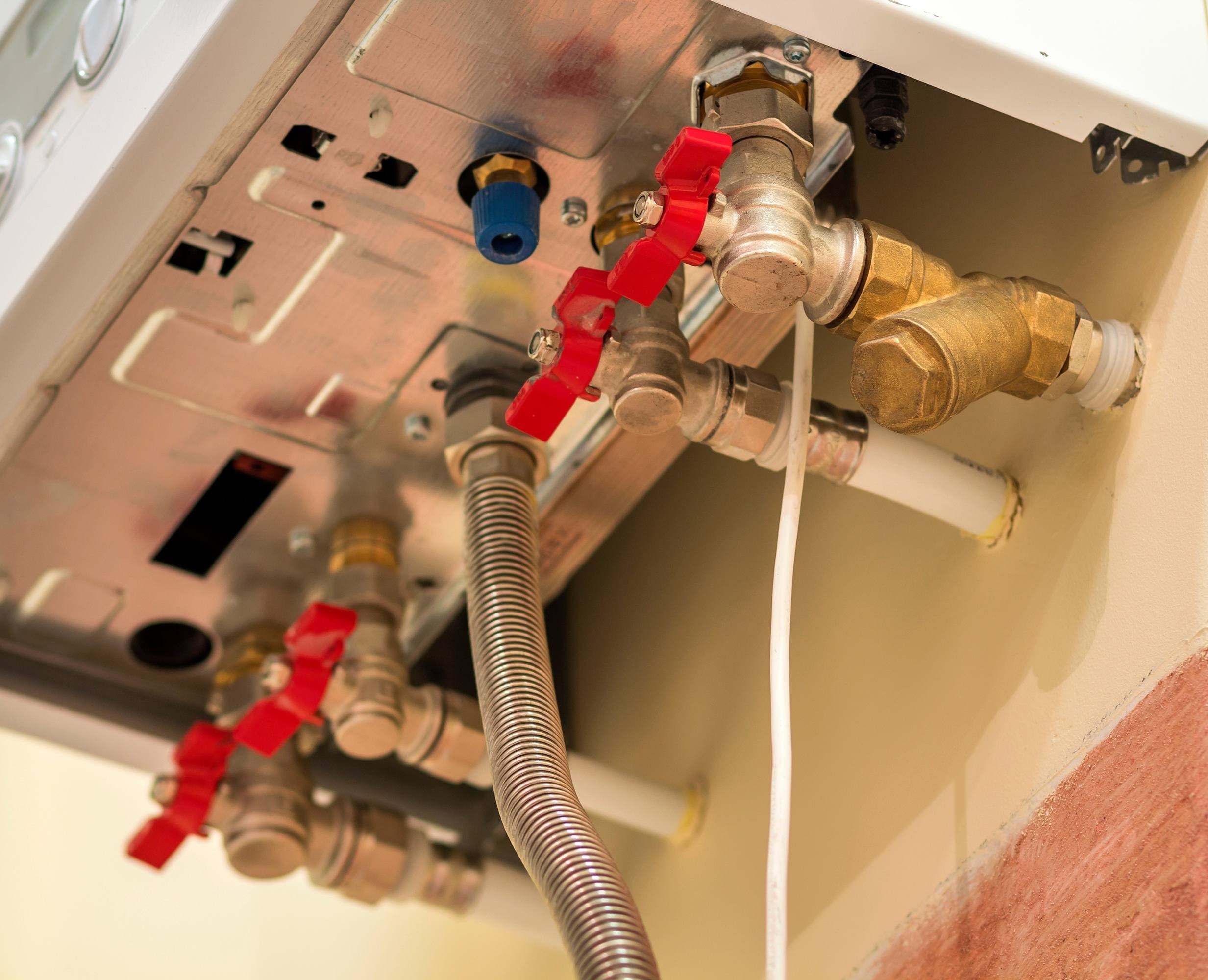 Two outdoor central air conditioning units installed on concrete pads next to a building, ready for operation.